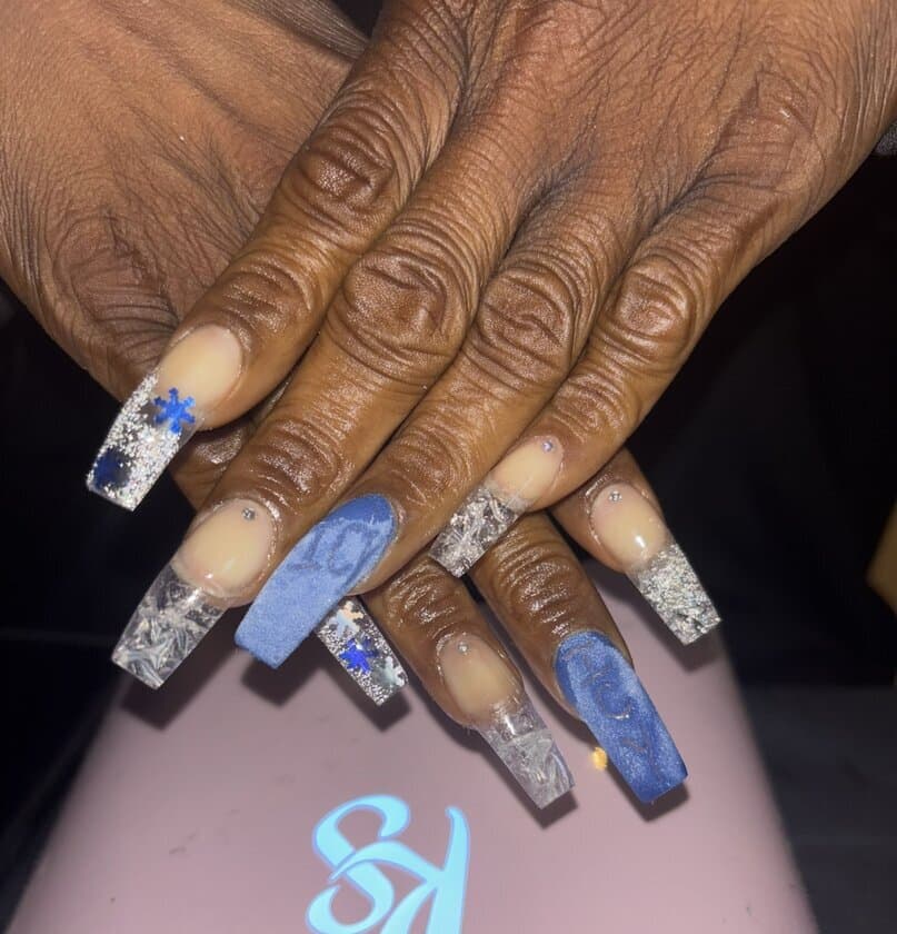 Long coffin acrylic set in icy blue with silver glitter, clear tips, snowflake nail art and rhinestones — winter glam by Talons by Byrd