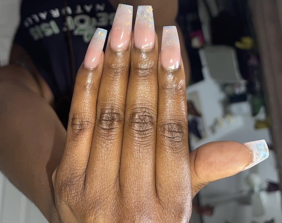 Milky white ombré coffin nails accented with delicate gold-foil flakes by Talons by Byrd